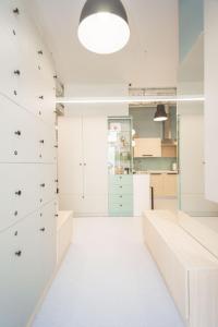 a dressing room with white cabinets and drawers at CAPSULE HOTEL & HOSTEL in Kharkiv