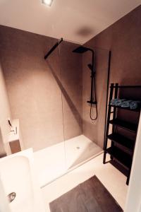 a bathroom with a shower with a glass door at Floride, The Perfect Getaway in Koksijde
