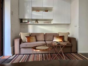 a living room with a couch and a table at Jolie Apartments in Kaunas