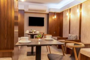 a room with a table and chairs and a tv at Union Hotel Port in Istanbul