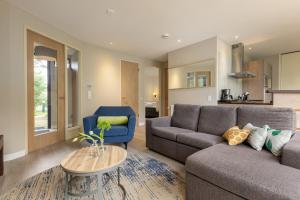 a living room with a couch and a table at Center Parcs Heijderbos Limburg-Weeze in Heijen