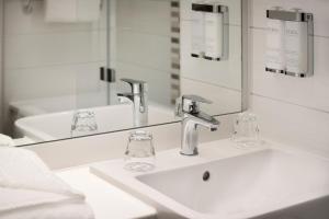 a bathroom with two sinks and a mirror at Leonardo Hotel Chester in Chester