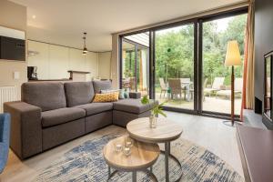 a living room with a couch and a table at Center Parcs Heijderbos Limburg-Weeze in Heijen