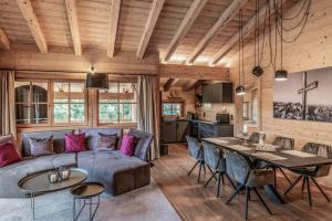 a living room with a couch and a table at Benglerwald Berg Chaletdorf in Bach