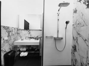 a bathroom with a shower and a sink at Bed, Bites & Business Hotel Rotterdam in Rotterdam