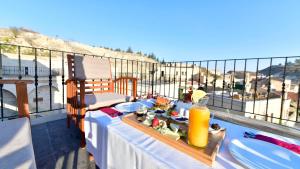 a table with a tray of food on a balcony at Cappadocia Estates Hotel in Mustafapaşa