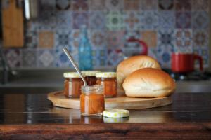 a counter with buns and jars of jam on a table at Casa Vinci in Siracusa