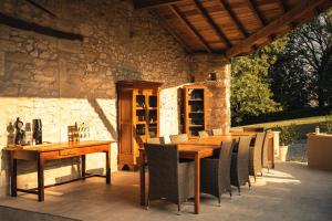einen Holztisch und Stühle auf einer Terrasse in der Unterkunft Domaine de Merugat Chambre d'Hôtes in Valeilles