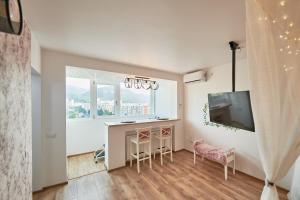 a living room with a bar and a tv and a window at Romantic Studio in Braşov