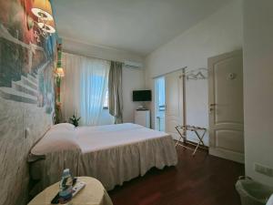 a hotel room with two beds and a table at A due passi olbia in Olbia