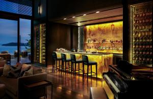 a bar with chairs and a piano in a room at V Villas Phuket - MGallery Collection in Panwa Beach