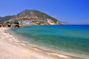 a view of a beach with a hill in the background at bougainvilla in Fodele