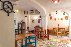 a room with tables and chairs and a clock at Hotel la Maggioressa in Casamicciola Terme