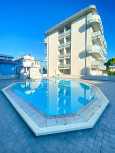 una grande piscina di fronte a un edificio di Residence Caorle a Caorle