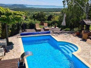 a swimming pool with a view of the mountains at Panorama Pool Residence in Balatonfüred