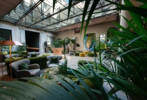a lobby with couches and plants in a building at Monaco & Grand Canal in Venice