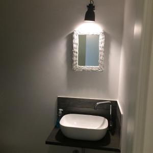a bathroom with a sink and a mirror at Pikaret Bed&Breakfast in Corato