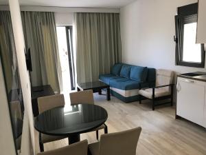 a living room with a blue couch and a table at REZEVICI BOUTIQUE VILLA in Petrovac na Moru