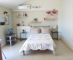 a bedroom with a bed with pink flamingos on the wall at Vacations in Patra in Patra