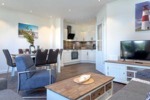 a living room with a kitchen and a dining room at Haus Jensen 2 in List