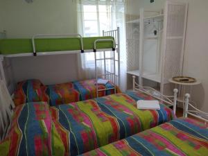 two beds in a room with two bunk beds at B&B Arquino in Sondrio