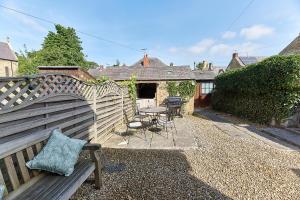 a garden with a wooden fence and a table and chairs at Host & Stay - Waterleap Cottage in Ovingham