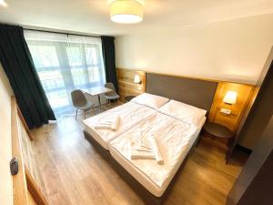Postel nebo postele na pokoji v ubytování Villa Pinus Slovenský raj - Hotel Čingov dependance