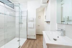 a bathroom with a glass shower and a sink at Hyper Centre 16 rue Valdemaine in Angers