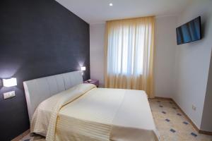 Postel nebo postele na pokoji v ubytování La Suite del Faro