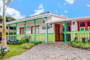 a colorful house with red and green trim at Hotel Mirador de Boquia Salento in Salento