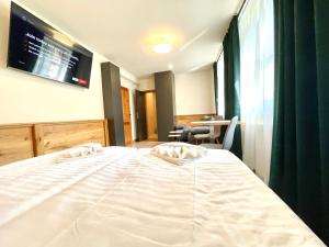 Postel nebo postele na pokoji v ubytování Villa Pinus Slovenský raj - Hotel Čingov dependance