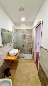 a bathroom with a sink and a shower at Scapriccio Relax in Serrara Fontana +17 photos