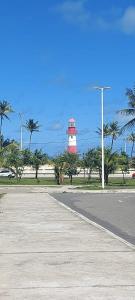 a red and white lighthouse on the side of a road at Duna´s guest house in Salvador