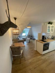 a kitchen and a living room with a table and a kitchen and a kitchen at Goethestrasse Appartements in Hameln