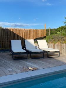 two lounge chairs sitting next to a swimming pool at BB La Marinière in Theux