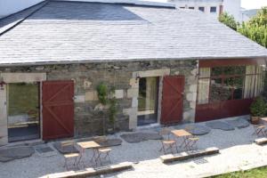 a group of chairs sitting outside of a stone building at CASA SOLANCE in Sarria