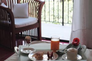 a table with a tray of food and coffee on it at Torre Bennistra in Scopello
