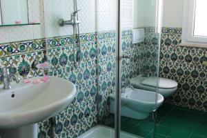 a bathroom with a sink and a toilet at Torre Bennistra in Scopello