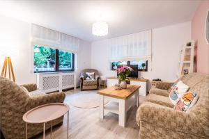 a living room with two couches and a table at River House in Bran