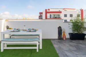 a white table and bench on a patio at Swell House in Ferrel