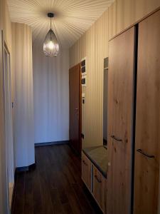 a room with a hallway with a wooden floor and a chandelier at Studio Via Pontica in Varna City