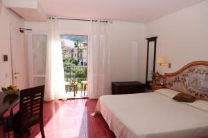 a bedroom with a bed and a large window at Torre Bennistra in Scopello