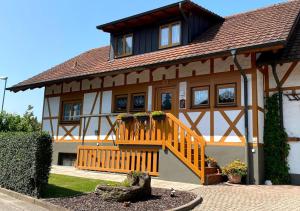 a large house with a staircase in front of it at Werner Ferienwohnung in Kappel-Grafenhausen