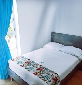 a bed sitting in a room with a window at Hotel Plaza Mayor Itagui in Itagüí