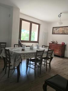 a dining room with a table with chairs and a dresser at Casa di Dattero in Quero