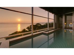 a house with a swimming pool with a view of the ocean at Kanzanji Sago Royal Hotel - Vacation STAY 43399v in Hamamatsu