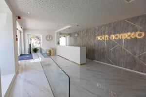 a lobby of a hotel with a sign on the wall at Hotel Mondego in Coimbra