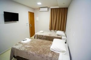 En eller flere senge i et værelse på Hotel Diamantte