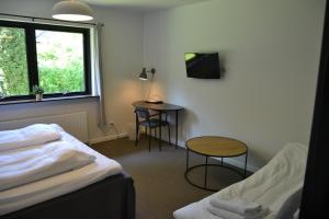 Ένα ή περισσότερα κρεβάτια σε δωμάτιο στο Dalby Hotel