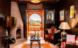 a living room with a fireplace and a couch at GreenLife Marrakech in Marrakech